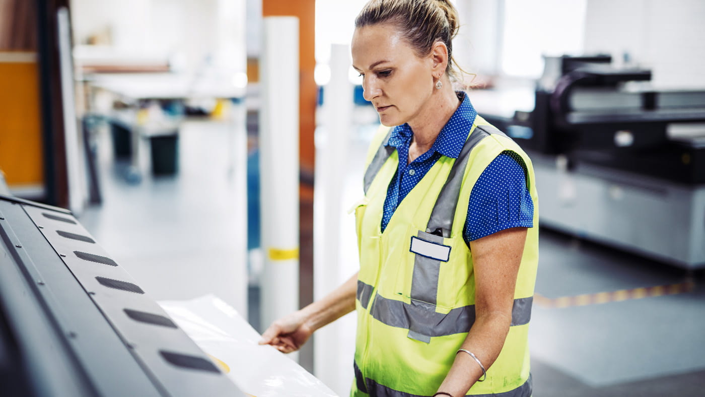 Female in hi vis at printer